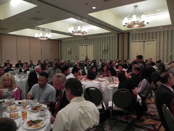 The chapter's July luncheon draws a large crowd for the scholarship presentations.